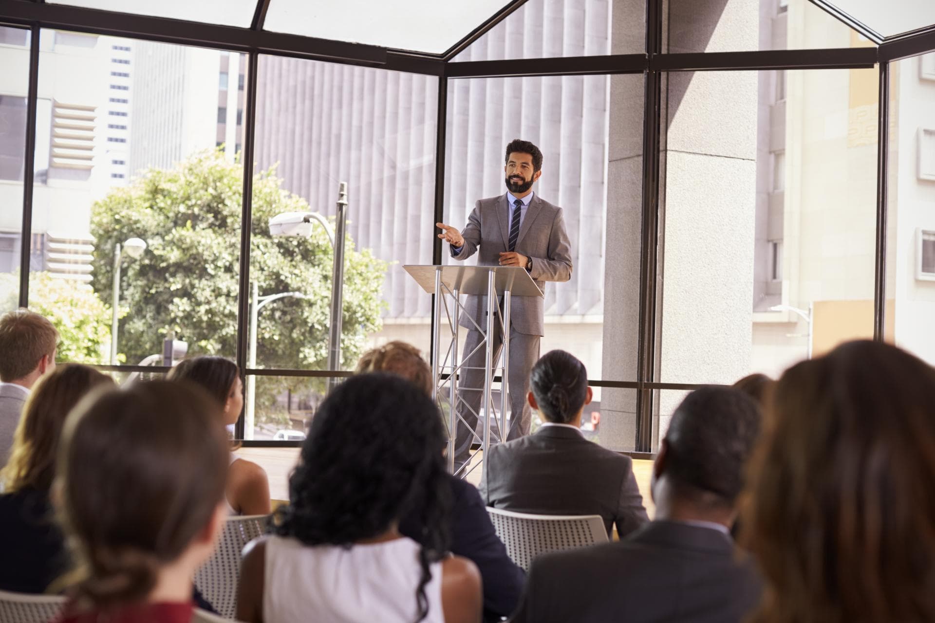 hispanic-man-presenting-business-seminar-to-audien-2024-10-19-02-30-56-utc
